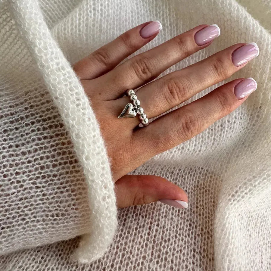 Handmade elastic love ring with geometric heart charm on beaded string