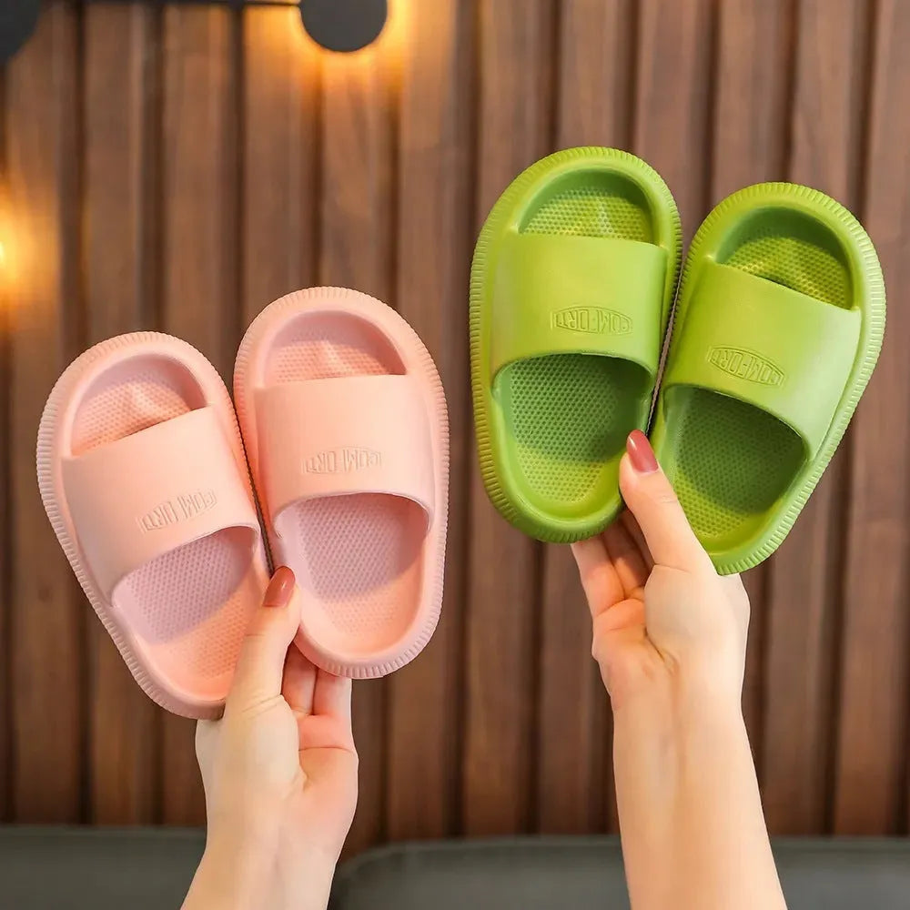 Children's colourful EVA slippers with a textured non-slip sole, shown in blue, green, orange, pink, and yellow.