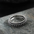 Geometric copper ring with a triangular zircon stone inlay, shown in white gold finish.