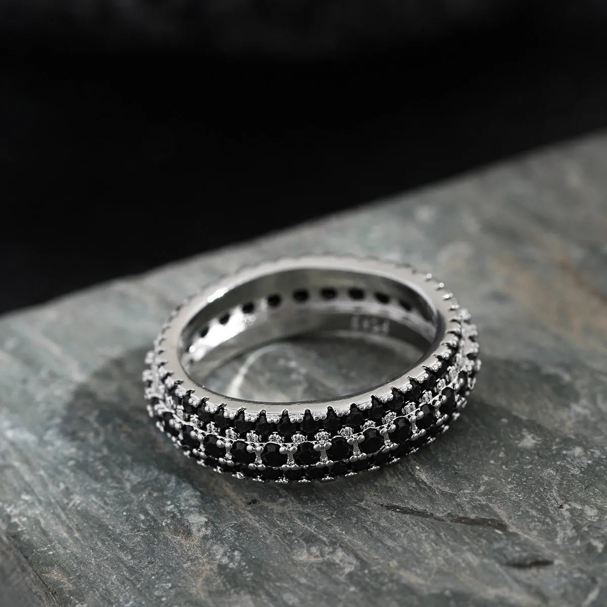 Geometric copper ring with a triangular zircon stone inlay, shown in white gold finish.