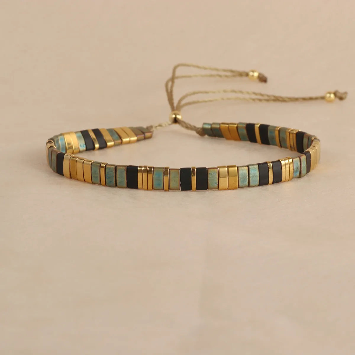 Geometric glass bead bracelet in milky white, black, retro green, light blue, or red colours.