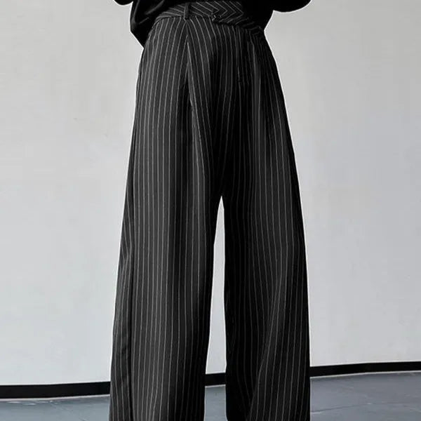 Men's black vertical striped pleated casual trousers showing elastic construction detail