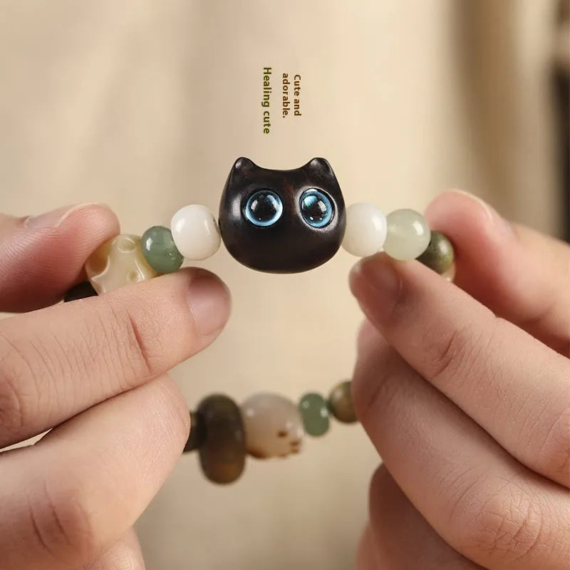 Hand-woven bracelet with jade guajacwood multi-treasure cube and cat's paw design in bodhi and ebony materials