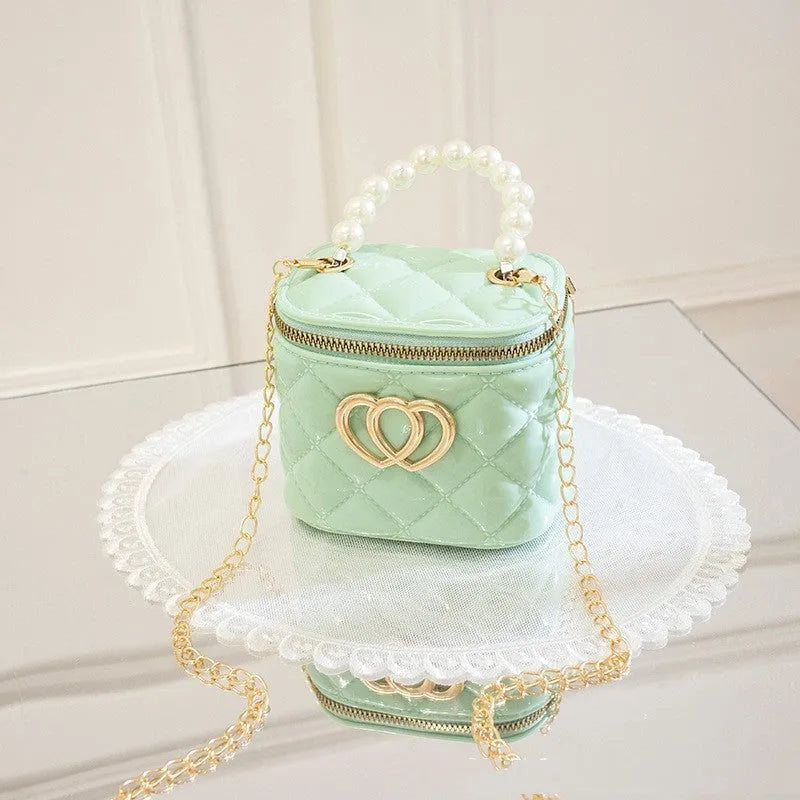 Women's PVC bucket gel bag with heart-shaped pattern in assorted colours.