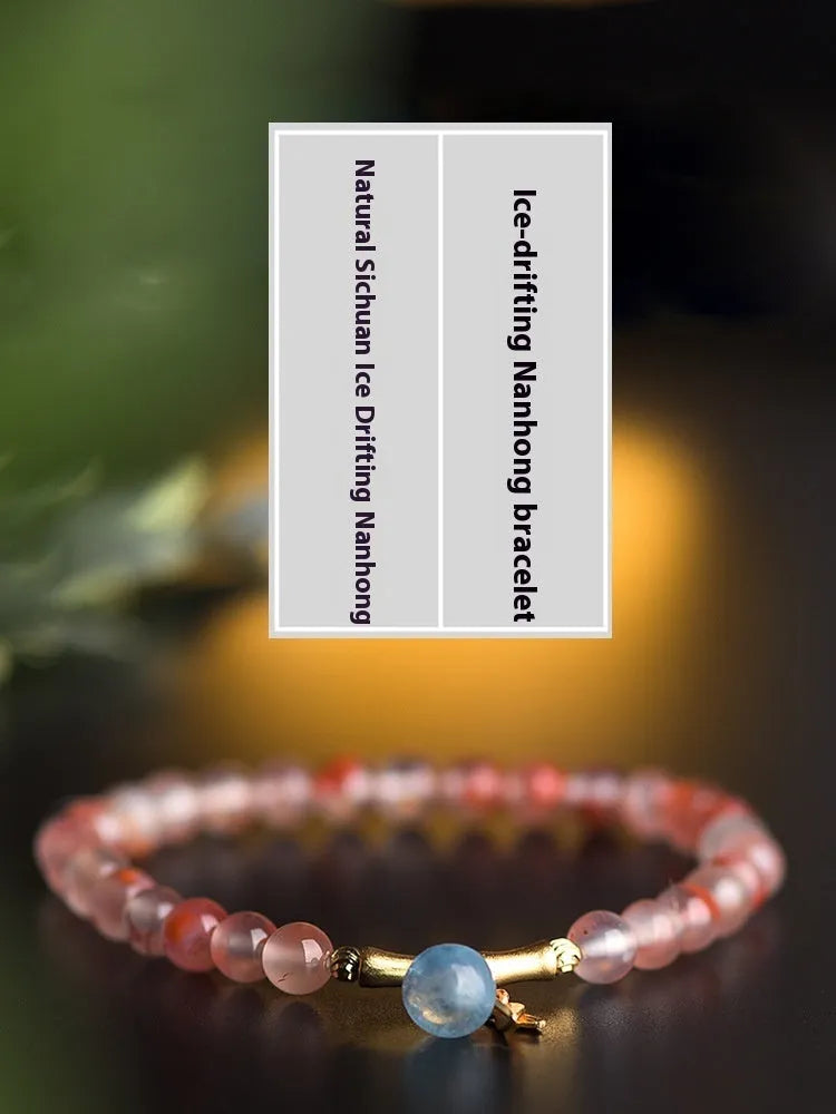 Ice float nanhong agate bracelet with floral shape and bamboo joint design on a wrist.