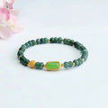 Close-up of a women's bracelet with blue water jade abacus beads in oval and round shapes on an adjustable band.