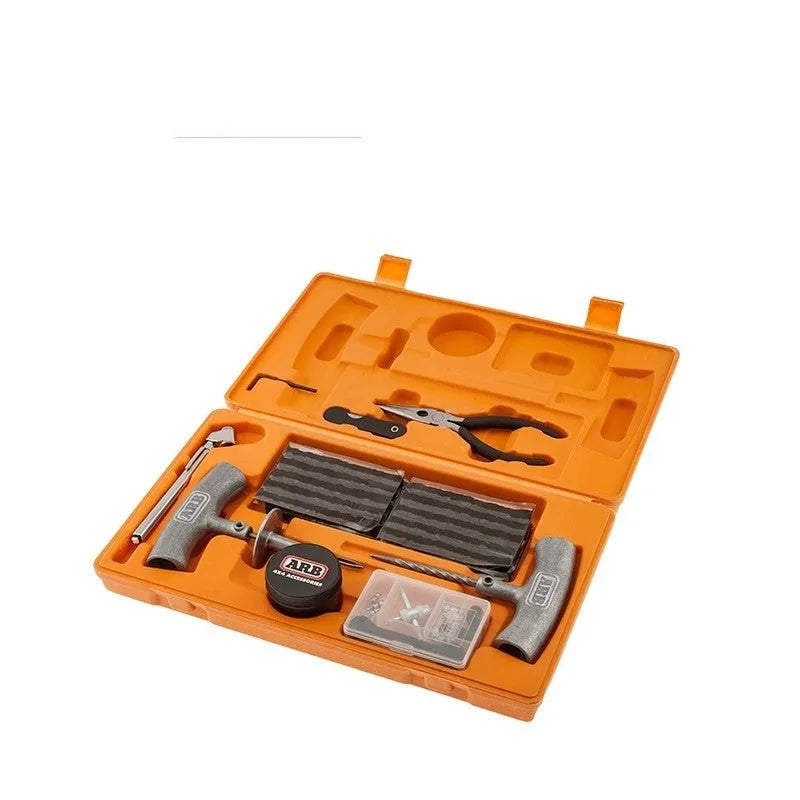 Emergency car tyre repair tool set with tools and pressure gauge in an orange suitcase case.