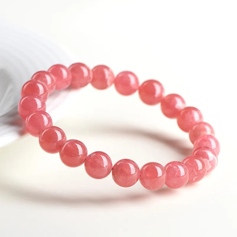Women's geometric crystal bracelet with Longevity Lock design and red rhodochrosite stone beads.