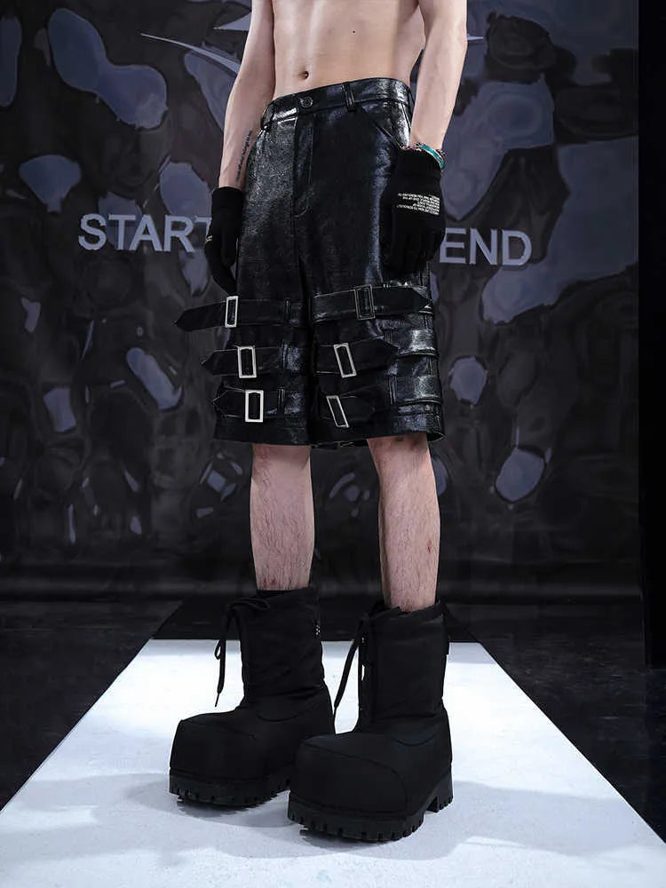 Black men's PU leather cropped pants on hanger showing low waist and flexible spandex material.