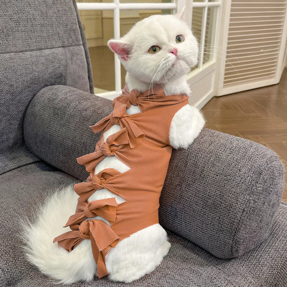 Lace-up polyester recovery clothing for a cat, shown in a choice of colours including blue, pink, and green pineapple.