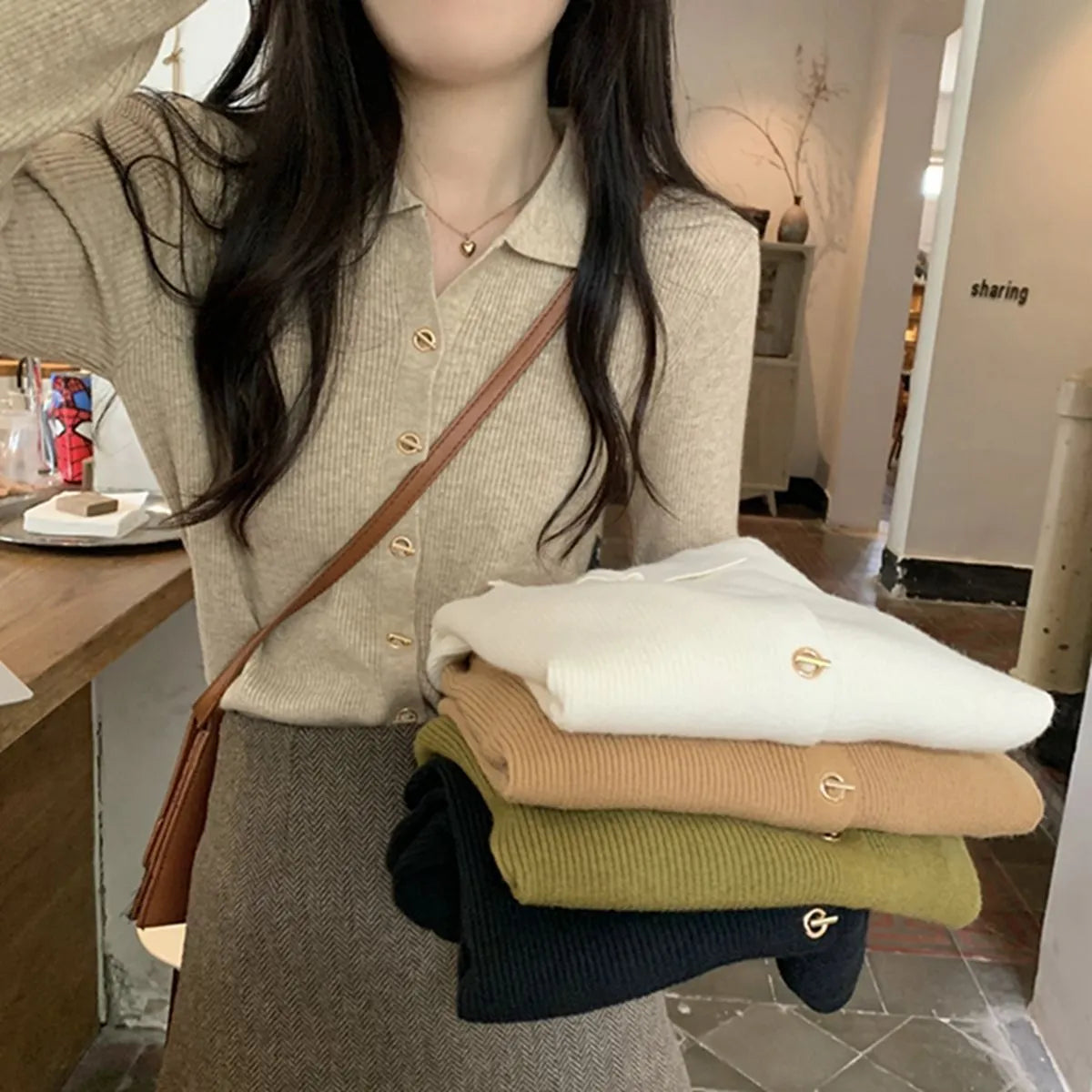 Long-sleeved loose-fitting viscose cardigan top in beige, shown worn open over a top