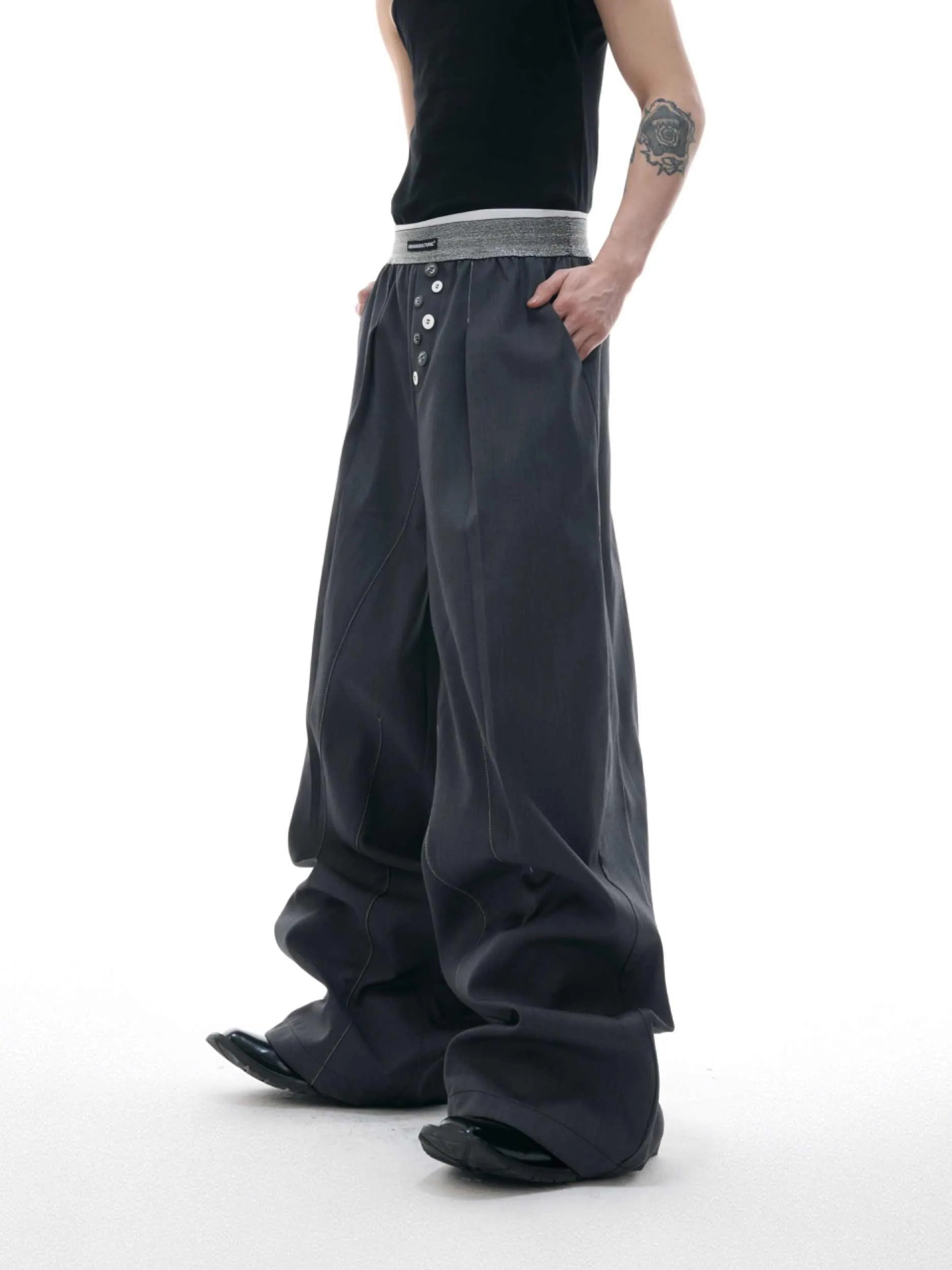 Black high-waisted straight-leg casual trousers featuring a button-open line design detail on the leg.