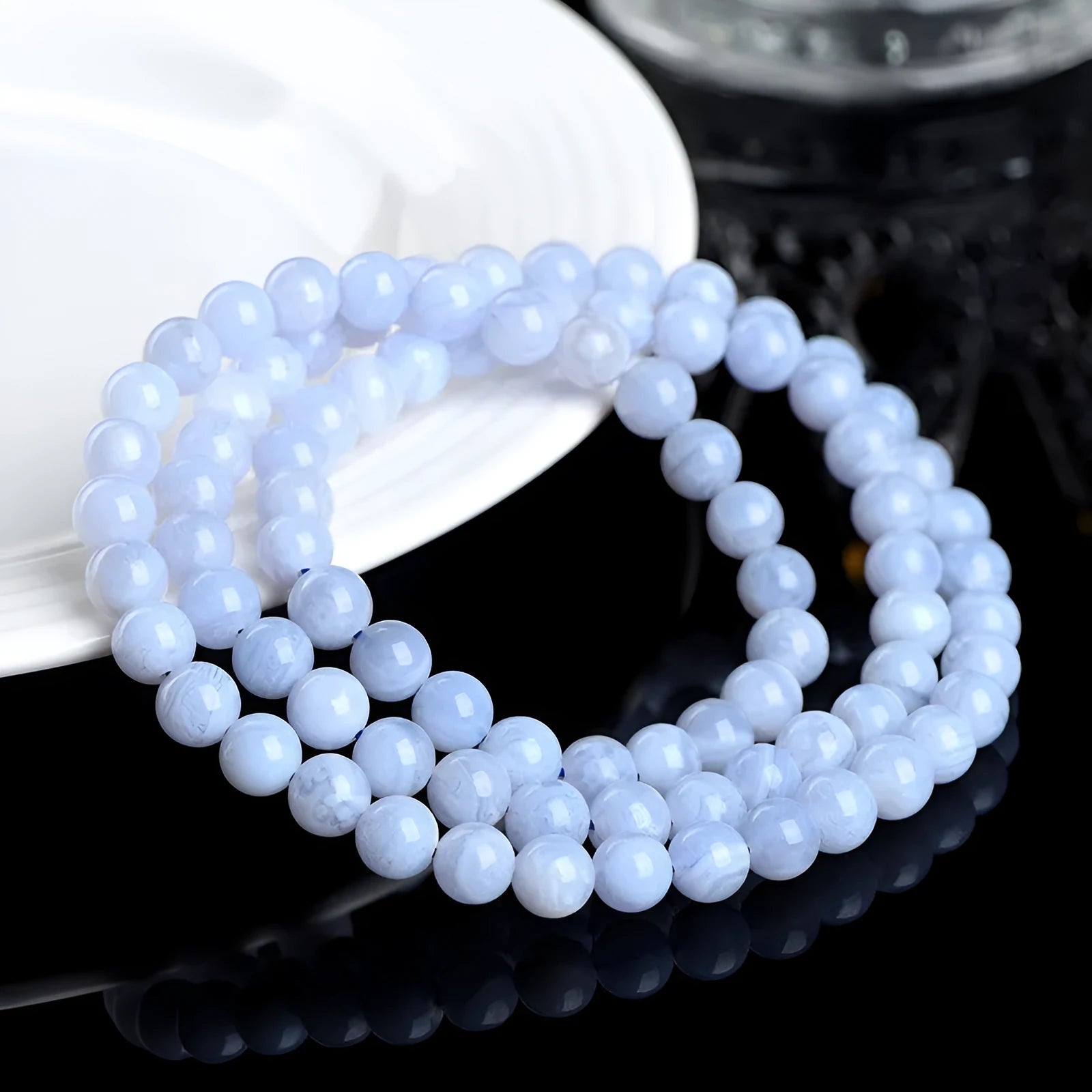 Natural blue agate bracelet with multi-circle pattern and a Ruyi charm.