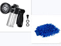 Green high-pressure foam spray gun with adjustable nozzle and connected water hose for car and garden cleaning.