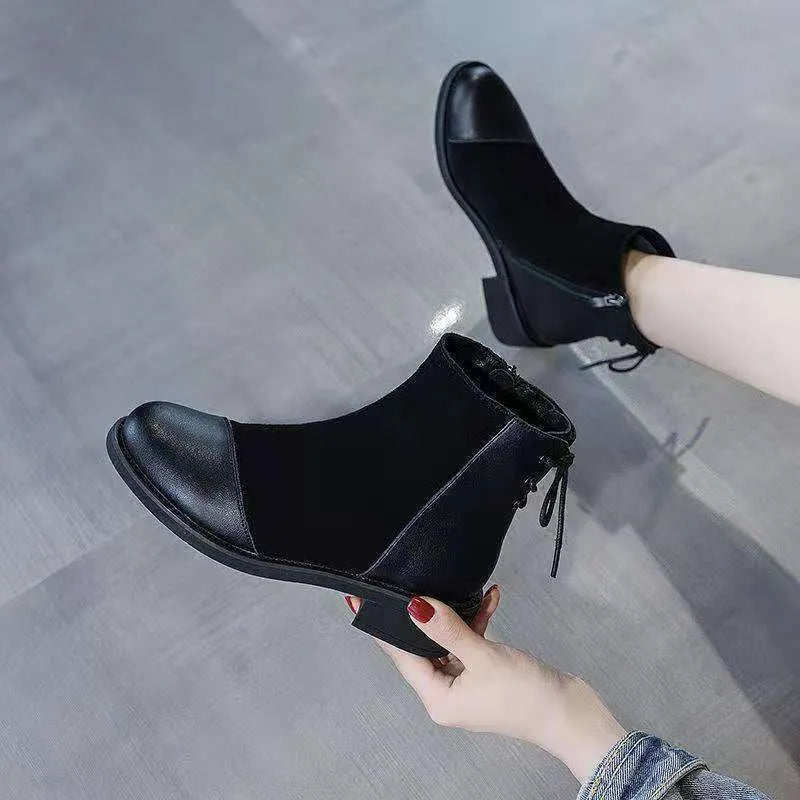 Black women's knee-high Martin boots with side zip and round toe.