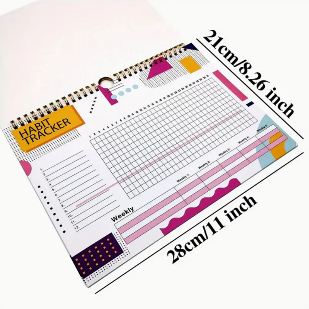 A5 habit tracking planner book open on a table, showing interior pages for schedule recording.