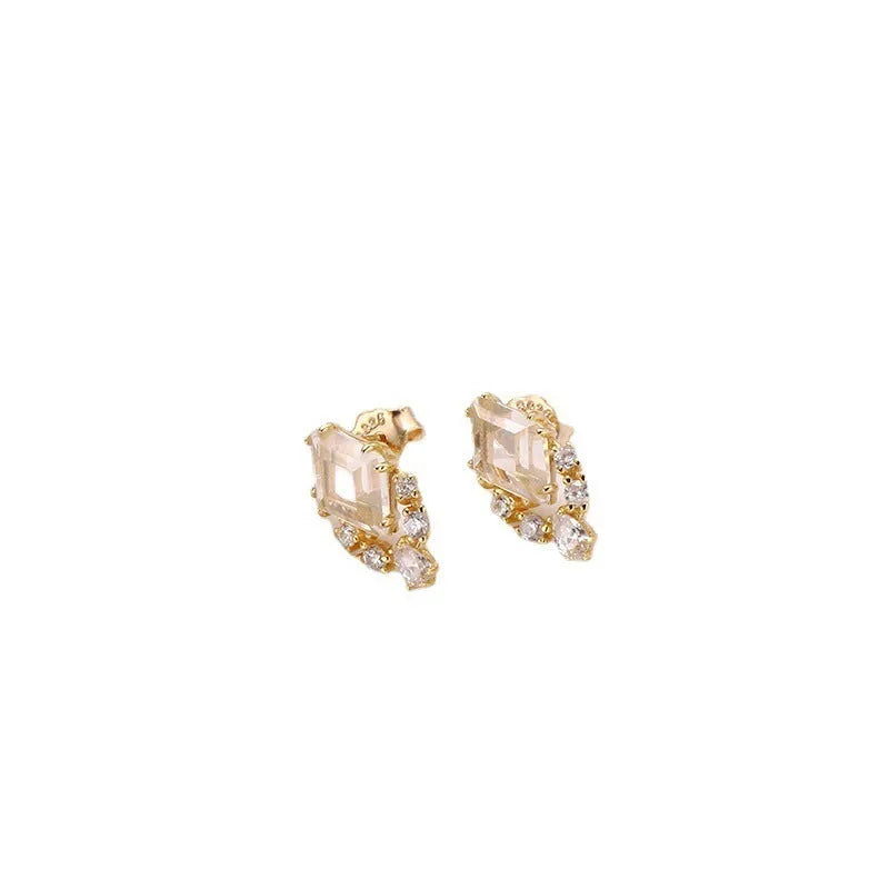 Geometric sterling silver earrings with sweet white crystal studs on white background