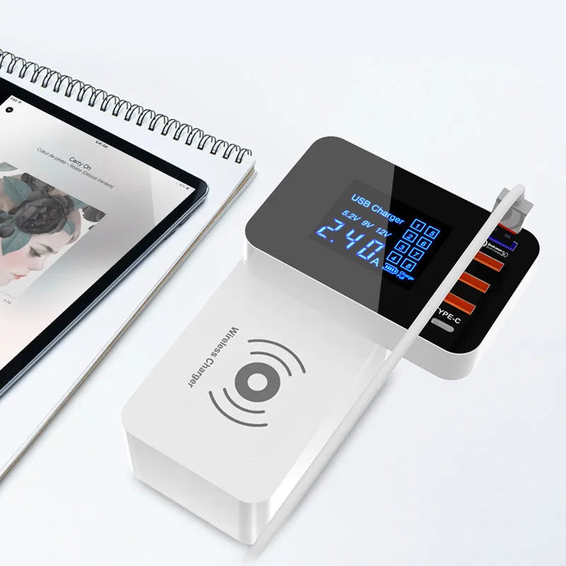 White multi-port USB fast charger with travel plug adapters and a long cable on a desk.