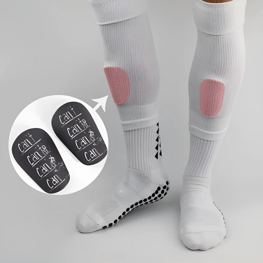 A pair of white and black PU football shin guards for S and XS sizes.