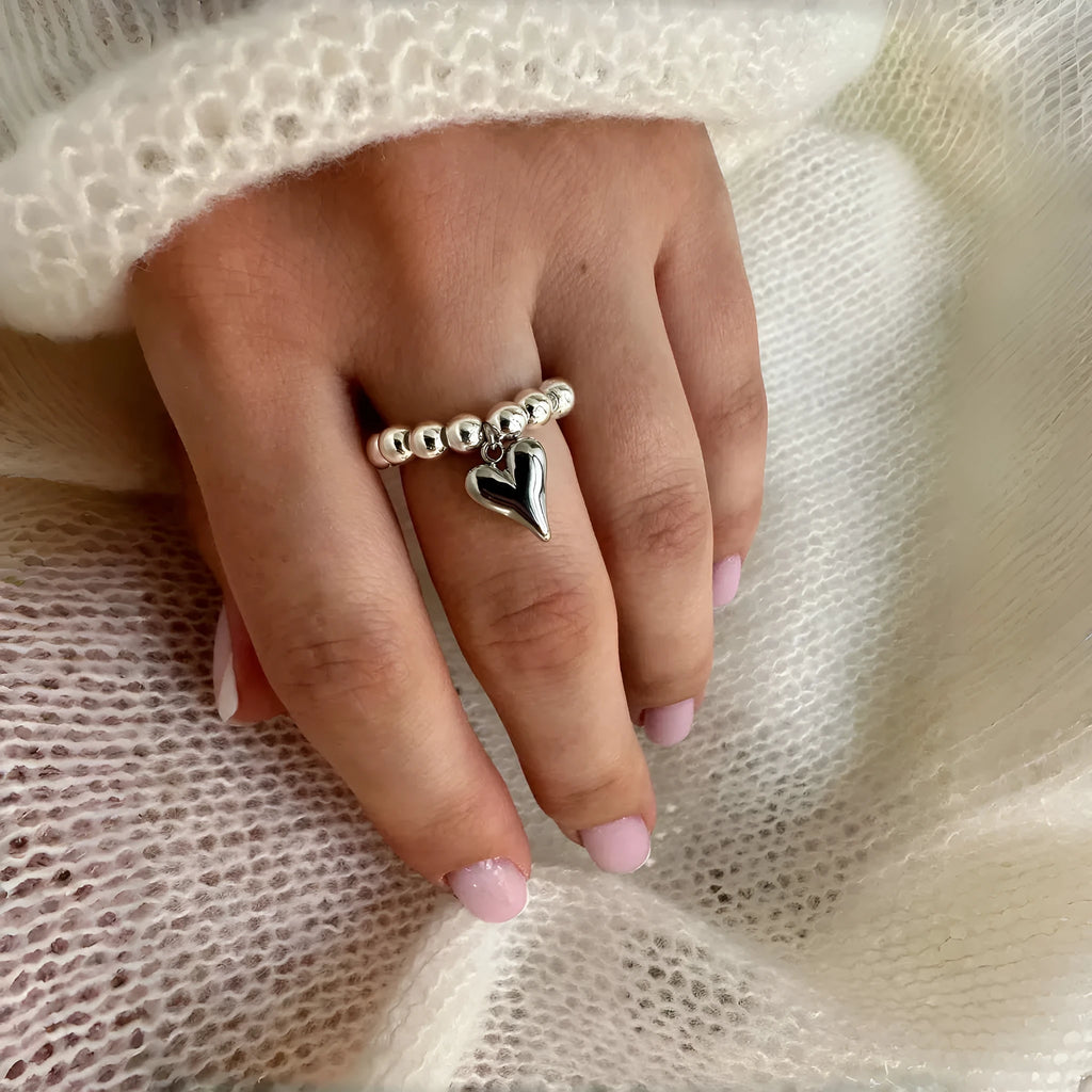 Handmade elastic love ring with geometric heart charm on beaded string