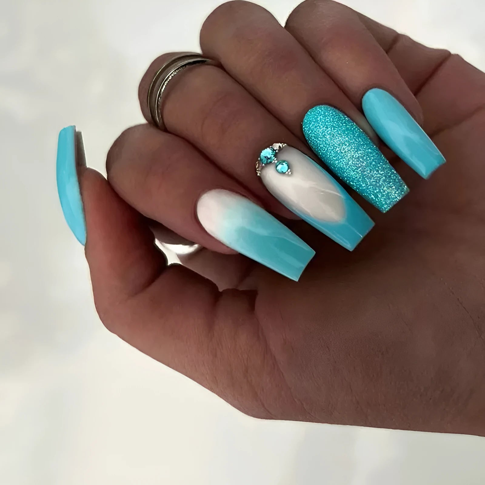 Solid colour long ballet false nails with blue diamond glitter and adhesive glue