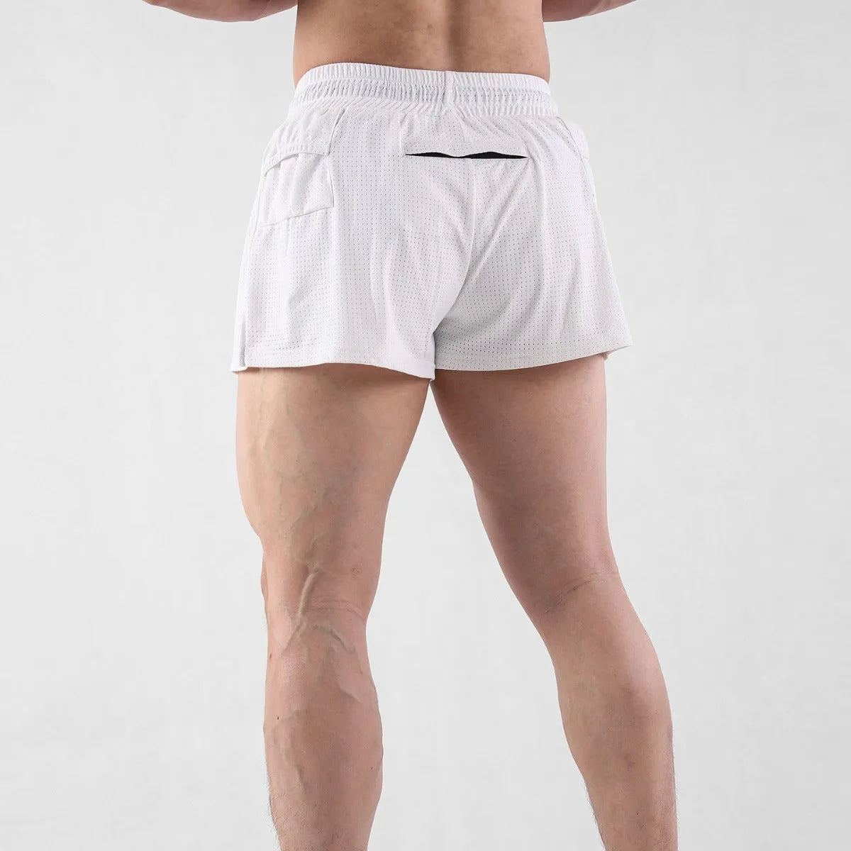 Man wearing black quick-dry nylon summer shorts with a mid-waist design.
