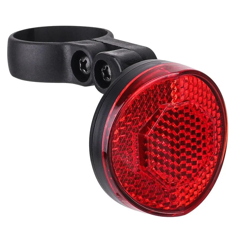 Red plastic bicycle taillight bracket mounted on seat post with reflective elements