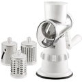 White plastic manual 3-in-1 vegetable slicer grater with stainless steel blades on a kitchen counter.