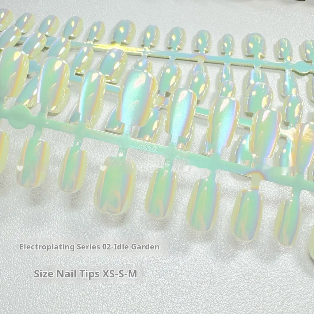 Set of electroplated Cat's Eye and Aurora effect press-on false nails in short ladder shape on a white background.