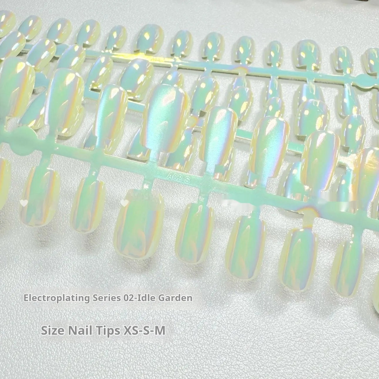 Set of electroplated Cat's Eye and Aurora effect press-on false nails in short ladder shape on a white background.