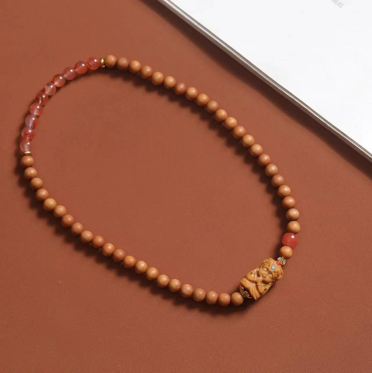 Brown wooden bracelet with sandalwood beads featuring South Red Zachilam and double circle design