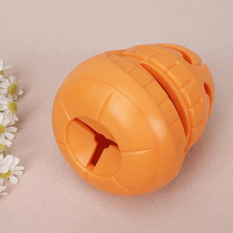 Yellow pumpkin-shaped TPR dog chew toy for aggressive chewers on a white background.