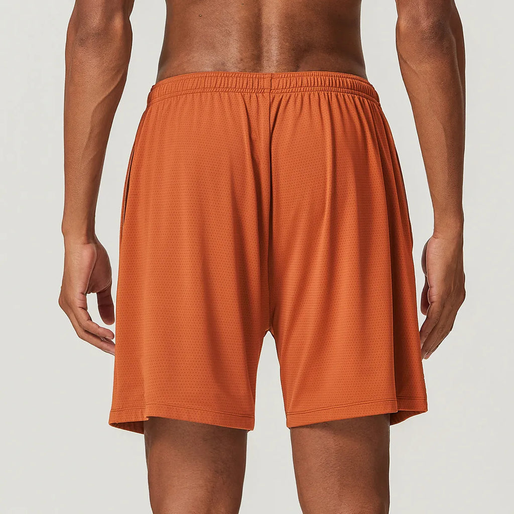 Men's double-layer quick-dry running shorts in brick red colour on a mid-waist fit model.