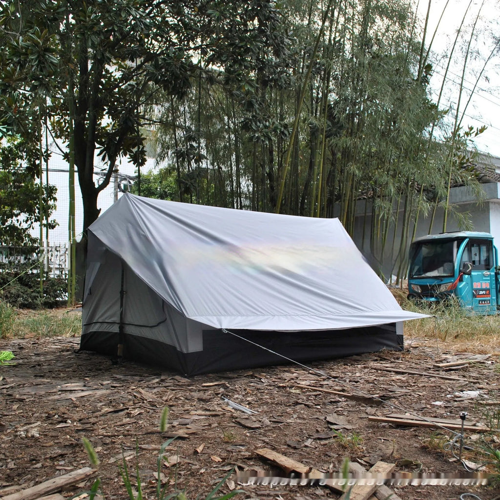 Brown A-line pole-free cabin tent pitched with hiking canes showing spacious interior dimensions