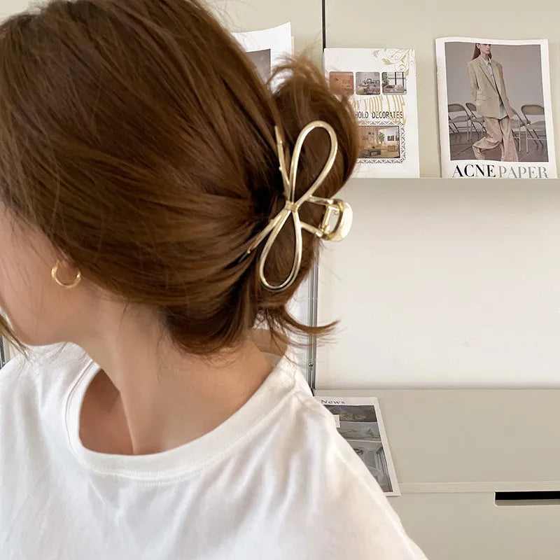 Women's bow hair barrette with back grip closure in gold or silver alloy