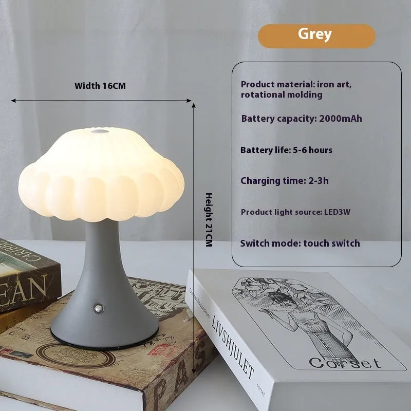 Touch control mushroom night light in wood grain colour on its wireless charging pad.