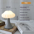 Touch control mushroom night light in wood grain colour on its wireless charging pad.