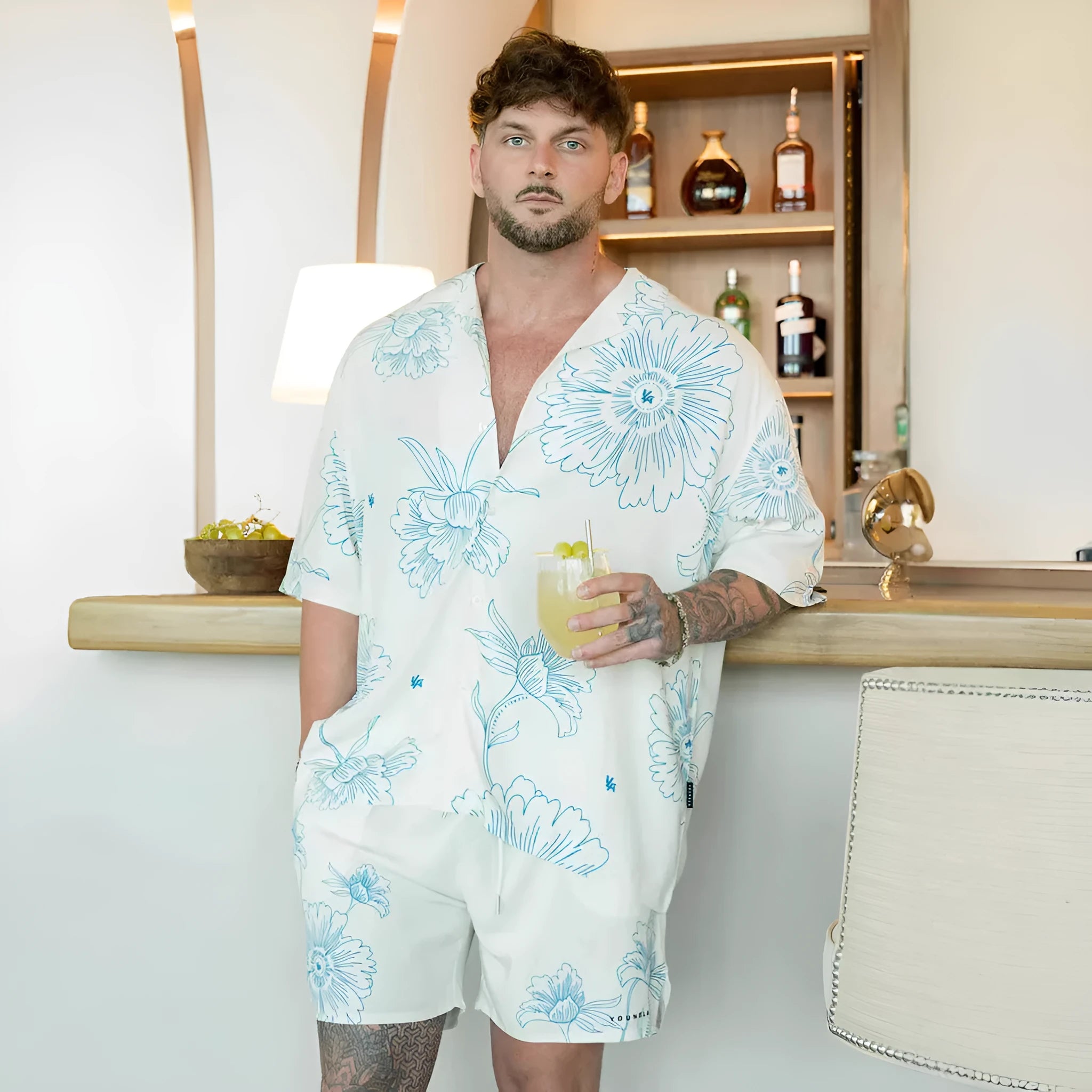 A loose-fitting short sleeve casual top with a floral print, shown in a light colour on a male model.