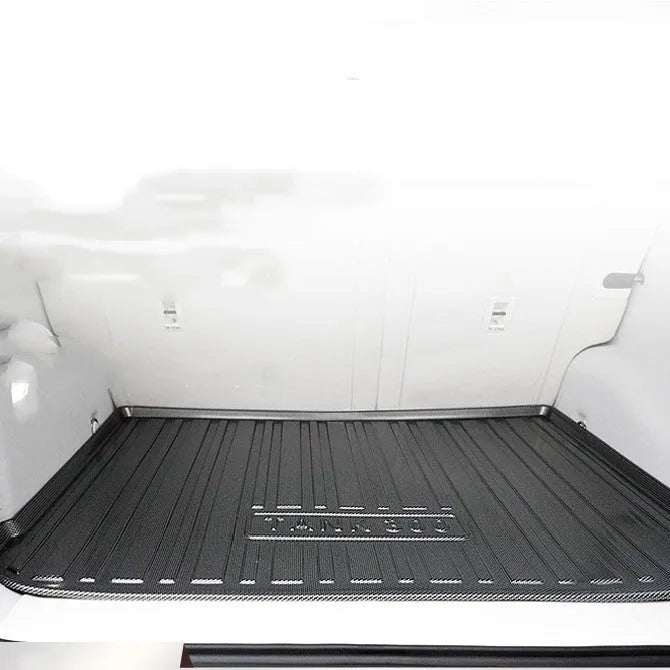 Black car boot protective mat with carbon fiber texture pattern, made from TPO+TPV material.