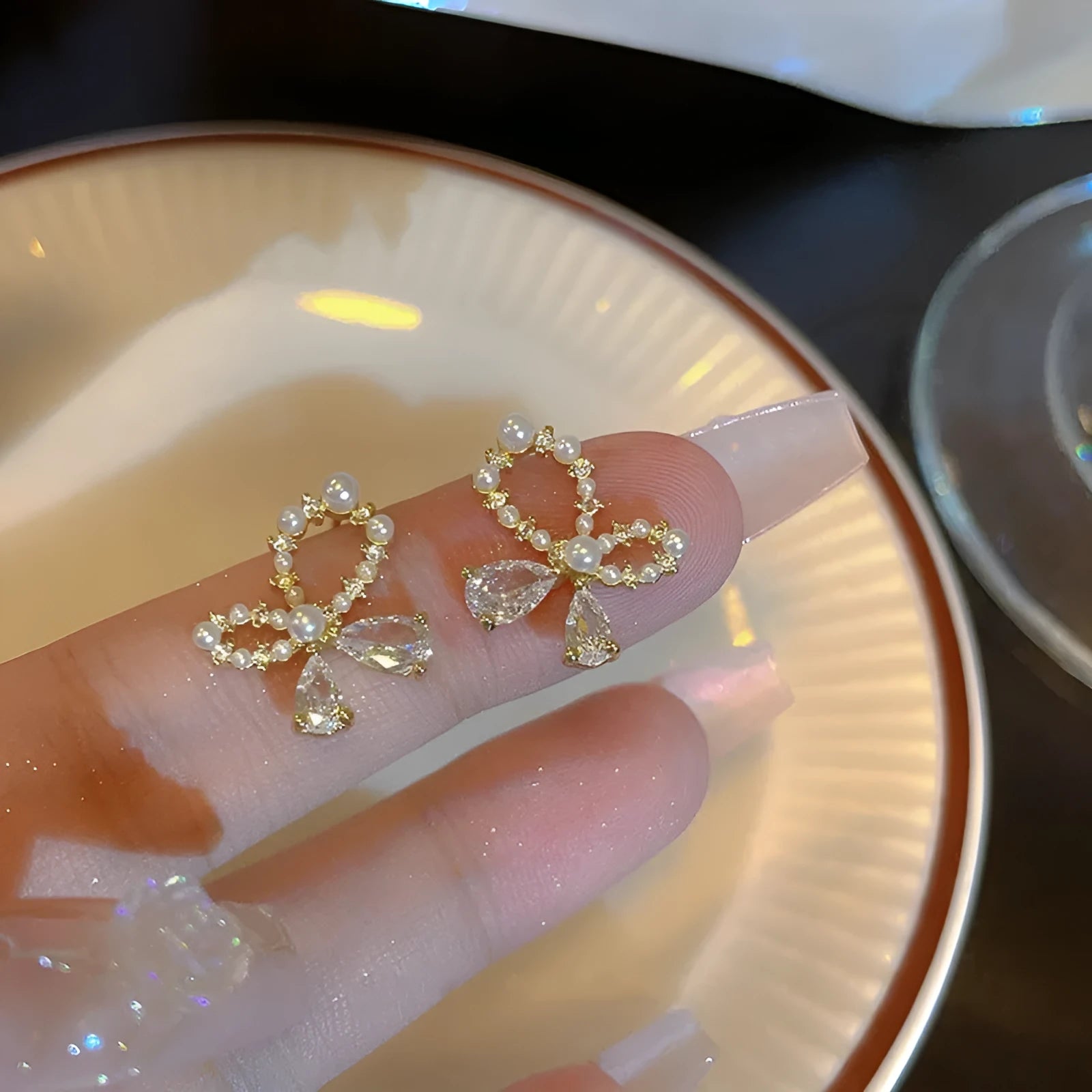 Silver electroplated copper butterfly earrings with geometric accents on a white background