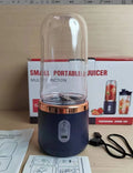 Portable dark blue blender and juicer with six blades, USB charging cable, and 400ml plastic cup.