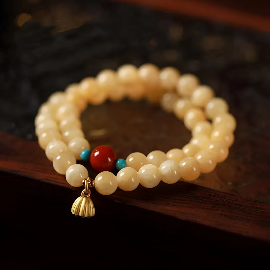 Yellow jade double ring bracelet with lotus seedpod design in hand-woven construction