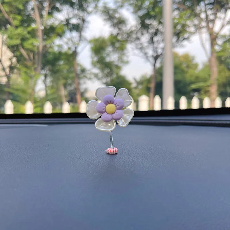 Small plastic colourful swing car decoration shown in multiple colour options.