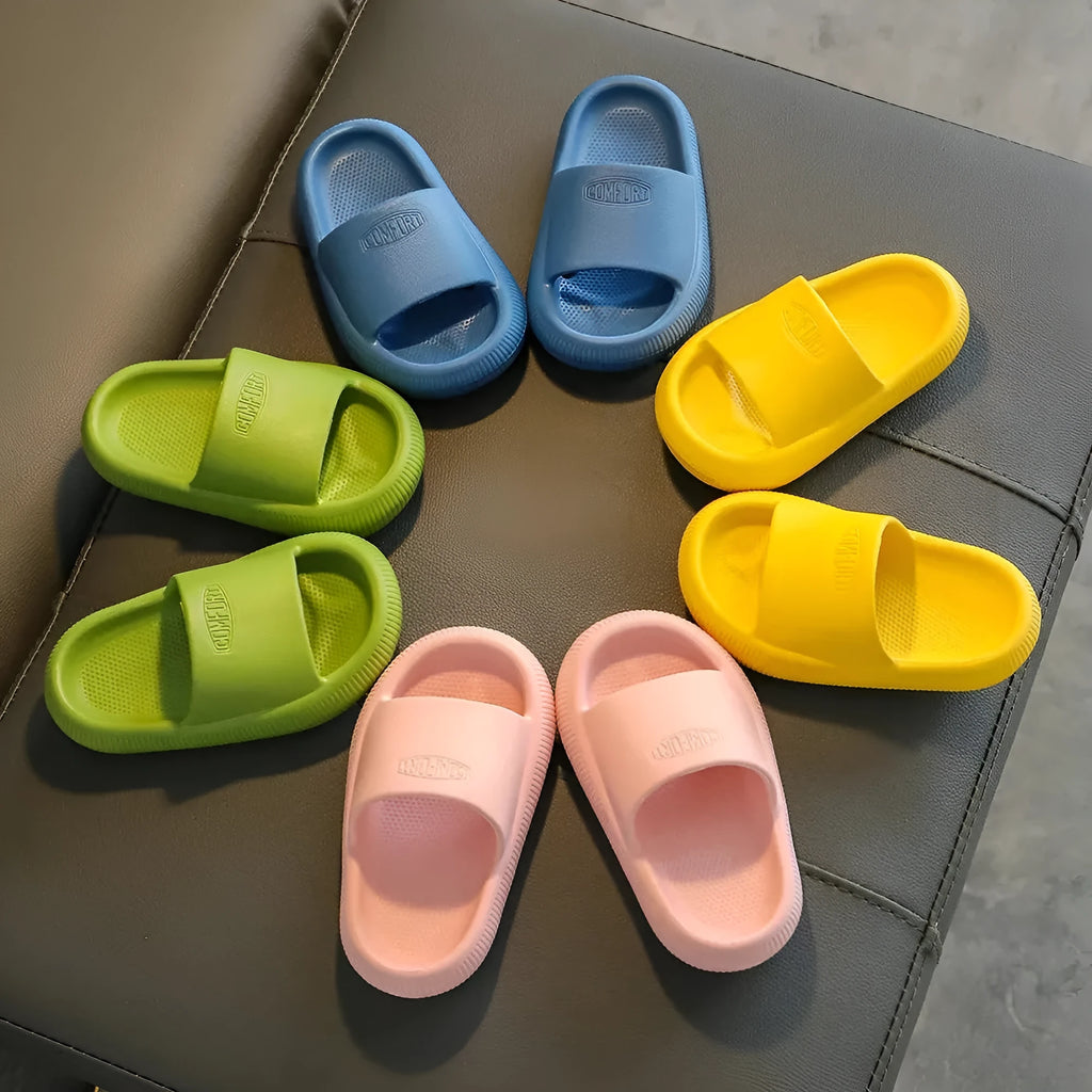 Children's colourful EVA slippers with a textured non-slip sole, shown in blue, green, orange, pink, and yellow.