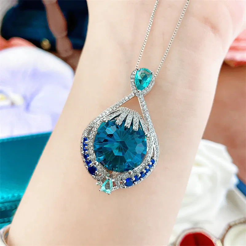 Geometric women's necklace with blue fireworks-cut crystal gems on a water wave chain.