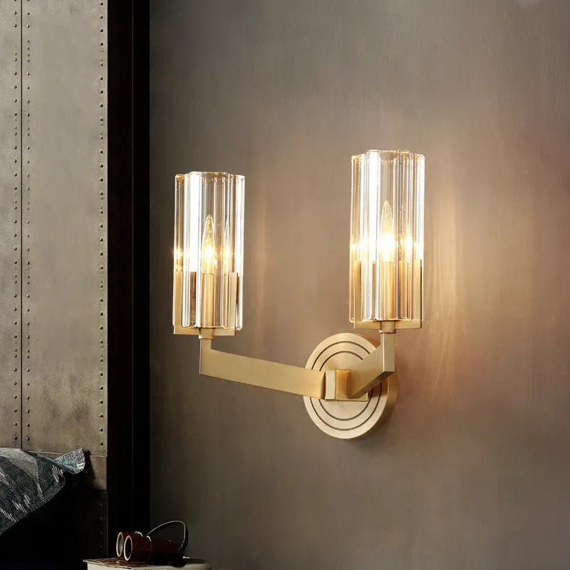Modern minimalist copper wall lamp with single head on a plain wall.