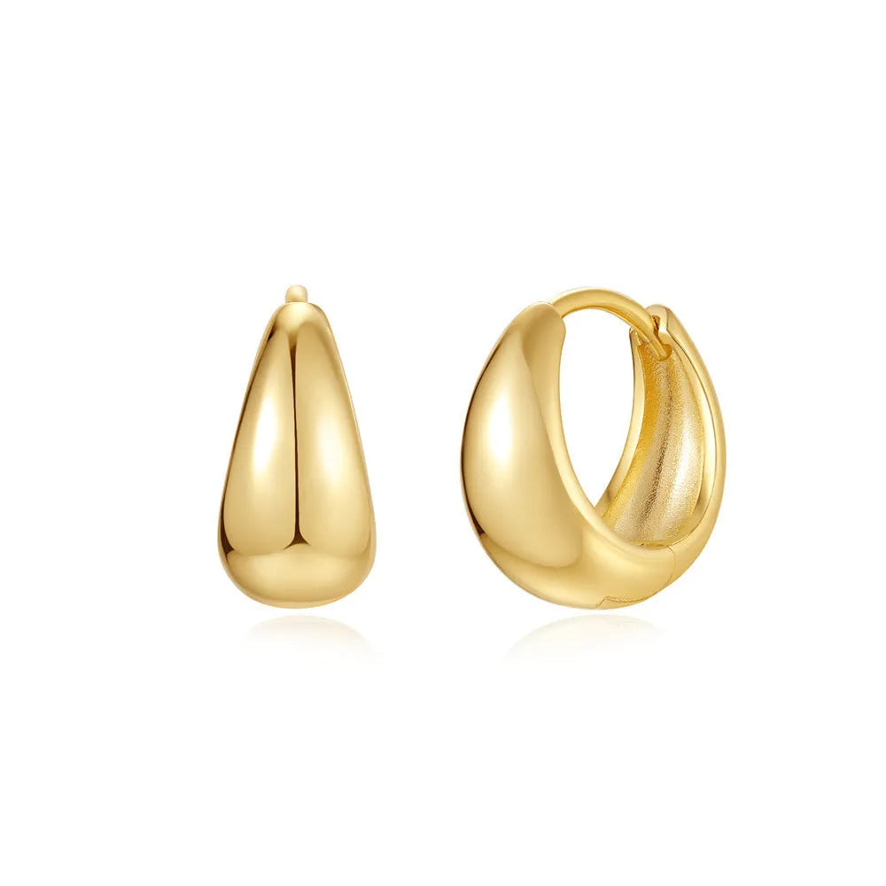 Geometric brass earclip earrings with a gold electroplated finish and round design details.