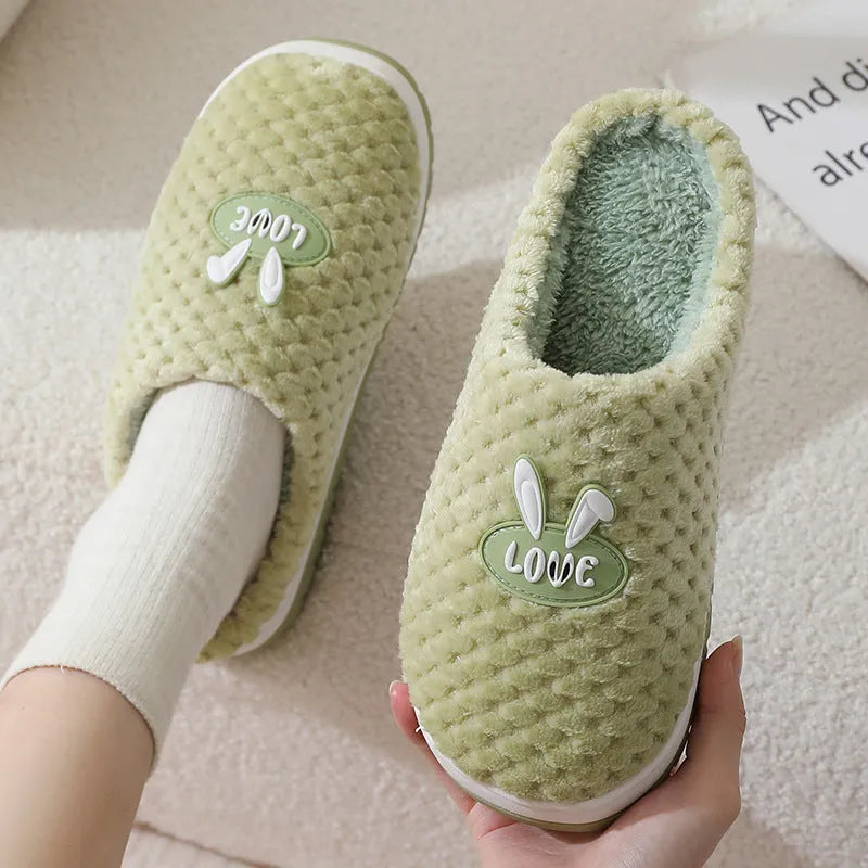 Women's plaid design house slippers with artificial fur upper and thick rubber sole in various colours.