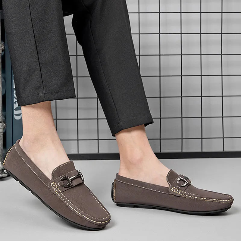 Men's brown leather slip-on loafers with a round toe and rubber sole.
