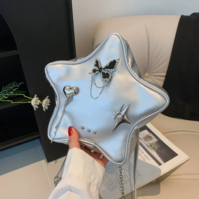 Black PU leather street style backpack with a detachable star-shaped butterfly pendant and chain strap.